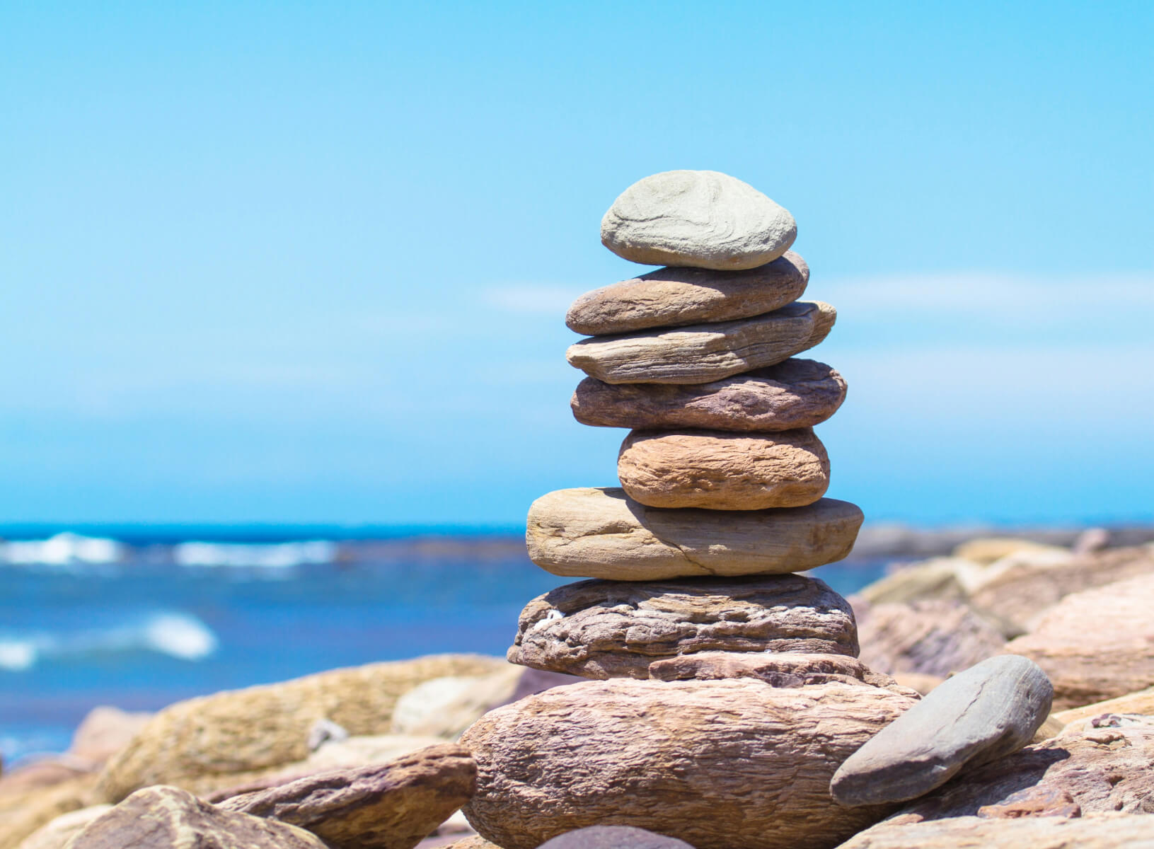 flat stones stacked on each other on the beach